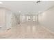 Bright, airy living room with tile flooring and neutral walls that leads to the upper floor at 2409 Bellinzona Pl, Henderson, NV 89044