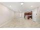 Large, open living space featuring tiled floors and sightlines to an island with a breakfast bar and stainless appliances at 2409 Bellinzona Pl, Henderson, NV 89044