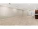 Spacious living room with neutral walls, tile floors, and ample natural light at 2409 Bellinzona Pl, Henderson, NV 89044