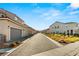 A sunny street view showcases the charming neighborhood with well-maintained landscaping at 2409 Bellinzona Pl, Henderson, NV 89044