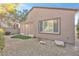 Back of the house featuring an enclosed patio and xeriscaped backyard with desert landscaping at 2444 Gamma Ray Pl, Henderson, NV 89044