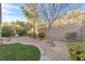 Serene backyard featuring artificial lawn and gravel landscaping at 2444 Gamma Ray Pl, Henderson, NV 89044