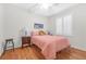 Comfortable bedroom with hardwood floors and bright natural light from the large window at 2444 Gamma Ray Pl, Henderson, NV 89044