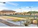 Well-maintained bocce ball court featuring a green surface area, covered benches, and overhead lighting at 2444 Gamma Ray Pl, Henderson, NV 89044