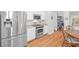 Modern kitchen featuring stainless steel appliances, white cabinetry, and a cozy breakfast nook area at 2444 Gamma Ray Pl, Henderson, NV 89044