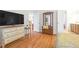 Spacious main bedroom features hardwood floors, TV, and an en-suite bathroom at 2444 Gamma Ray Pl, Henderson, NV 89044