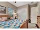 Charming bedroom with a cozy quilt bed, complemented by neutral decor and natural light at 2583 Hazelburn Ave, Henderson, NV 89044