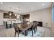 Bright dining room featuring a large wooden table and chairs, flowing seamlessly into the modern kitchen at 2583 Hazelburn Ave, Henderson, NV 89044