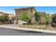 Charming two-story home with stone accents, a well-manicured lawn and three-car garage at 2583 Hazelburn Ave, Henderson, NV 89044