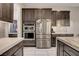 Modern kitchen features stainless steel appliances, gray cabinets, and a stylish island counter with seating at 2583 Hazelburn Ave, Henderson, NV 89044