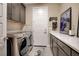 Well-organized laundry room features front load machines, ample storage, and stylish decor for functional elegance at 2583 Hazelburn Ave, Henderson, NV 89044