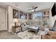 Inviting living room with a large sectional sofa, area rug, movie poster décor, and a ceiling fan at 2583 Hazelburn Ave, Henderson, NV 89044