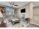 Inviting living room with a large sectional sofa, area rug, tv, movie poster décor, and a ceiling fan at 2583 Hazelburn Ave, Henderson, NV 89044