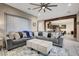 Spacious living room with a large sectional sofa and open view to the kitchen and dining areas at 2583 Hazelburn Ave, Henderson, NV 89044