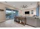 Modern living room with a gray sofa, view to patio and natural lighting at 2583 Hazelburn Ave, Henderson, NV 89044