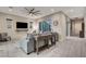Bright living room with modern decor, a gray sofa, and seamless access to outdoor patio at 2583 Hazelburn Ave, Henderson, NV 89044