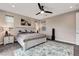 Bright main bedroom with a queen sized bed, a ceiling fan and a painting on the wall at 2583 Hazelburn Ave, Henderson, NV 89044