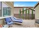 This patio features lounge chairs, a brick floor, and neatly trimmed trees for added privacy at 2583 Hazelburn Ave, Henderson, NV 89044