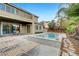 Backyard oasis features a sparkling pool, jacuzzi, covered patio, and lush landscaping for relaxation at 2583 Hazelburn Ave, Henderson, NV 89044