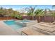Backyard oasis with a sparkling pool, jacuzzi, mature trees, and several lounge chairs at 2583 Hazelburn Ave, Henderson, NV 89044