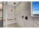 A tiled walk-in shower features a window with natural light and a built-in bench at 2583 Hazelburn Ave, Henderson, NV 89044