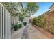The side yard has a stone walkway lined with tidy landscaping, offering a peaceful outdoor space at 2583 Hazelburn Ave, Henderson, NV 89044