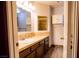 Bathroom featuring brown wood cabinets and countertops, plus a mirror and shower at 2611 S Durango Dr # 102, Las Vegas, NV 89117
