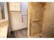Bathroom with tile shower, grab bars, vanity with white cabinet and a wall storage unit at 2611 S Durango Dr # 102, Las Vegas, NV 89117