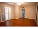 This light-filled bedroom features wood floors, a ceiling fan, and large windows with shutters at 2611 S Durango Dr # 102, Las Vegas, NV 89117