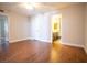 Open and airy bedroom with views into the bathroom and hallway, along with wood flooring at 2611 S Durango Dr # 102, Las Vegas, NV 89117