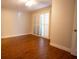 A bedroom showing the wood floors, baseboards, and large windows with shutters at 2611 S Durango Dr # 102, Las Vegas, NV 89117