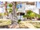 Charming condo exterior with mature landscaping, trees and covered walkways leading to the units at 2611 S Durango Dr # 102, Las Vegas, NV 89117