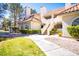 Beautiful exterior view of the condominium with lush green grass, mature trees and well-maintained landscaping at 2611 S Durango Dr # 102, Las Vegas, NV 89117