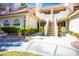 Inviting condominium exterior featuring well-maintained landscaping and a staircase leading to upper units at 2611 S Durango Dr # 102, Las Vegas, NV 89117