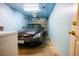 Single car garage featuring built in lighting with a gray sedan parked inside at 2611 S Durango Dr # 102, Las Vegas, NV 89117