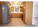Bright kitchen features stainless steel refrigerator, tile backsplash, and wooden cabinetry at 2611 S Durango Dr # 102, Las Vegas, NV 89117