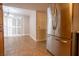 Bright kitchen featuring tile flooring, stainless steel refrigerator and a glimpse of the dining area at 2611 S Durango Dr # 102, Las Vegas, NV 89117