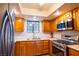 Well-lit kitchen features stainless steel appliances, tile backsplash, window, and light wood cabinetry at 2611 S Durango Dr # 102, Las Vegas, NV 89117