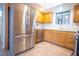 Well-lit kitchen featuring stainless steel appliances, wooden cabinets and a stylish backsplash at 2611 S Durango Dr # 102, Las Vegas, NV 89117