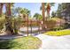 Community pool area with decorative metal fencing, lush landscaping, and mature trees at 2611 S Durango Dr # 102, Las Vegas, NV 89117