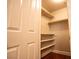 This is an image of a walk-in closet with shelving and hardwood floors at 2611 S Durango Dr # 102, Las Vegas, NV 89117