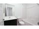 Bathroom with white sink vanity with dark cabinet and tub shower combo with white tile at 3542 Arcadian King Ave, Las Vegas, NV 89106