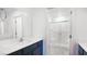 Bathroom featuring a walk-in shower with a glass door and a vanity with a dark cabinet at 3542 Arcadian King Ave, Las Vegas, NV 89106