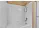 This bathroom features a tub and shower combination with white tiling at 3544 Desert Cliff St # 102, Las Vegas, NV 89129