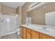 Well-lit bathroom featuring double sinks, a shower, and attractive decor at 3544 Desert Cliff St # 102, Las Vegas, NV 89129