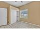 Comfortable bedroom featuring sliding-door closet, wood-look floors, and a window at 3544 Desert Cliff St # 102, Las Vegas, NV 89129