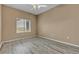 Bright bedroom with a ceiling fan and wood-look floors, offering ample natural light at 3544 Desert Cliff St # 102, Las Vegas, NV 89129