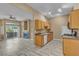 Open floor plan with living room, kitchen featuring all appliances and wood-style flooring at 3544 Desert Cliff St # 102, Las Vegas, NV 89129