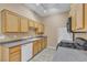 Bright kitchen featuring natural wood cabinets, modern appliances, and durable countertops at 3544 Desert Cliff St # 102, Las Vegas, NV 89129