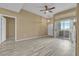 Bright open floor plan with wood-style flooring, patio access and neutral walls at 3544 Desert Cliff St # 102, Las Vegas, NV 89129